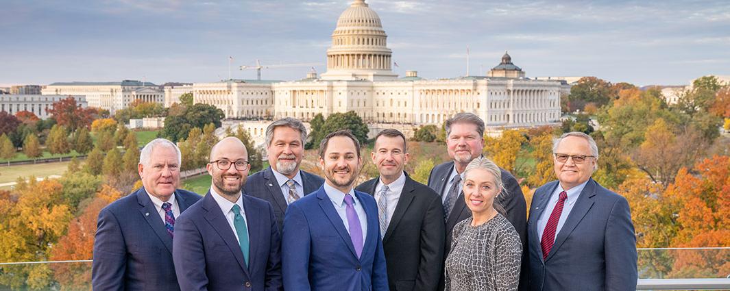 board members and government affairs team standing in front of capitol